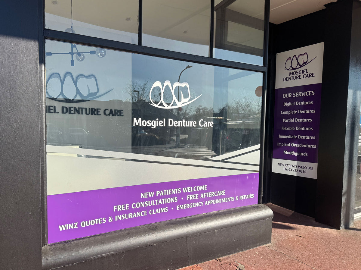 Mosgiel Denture Care storefront with glass window and promotional signs.